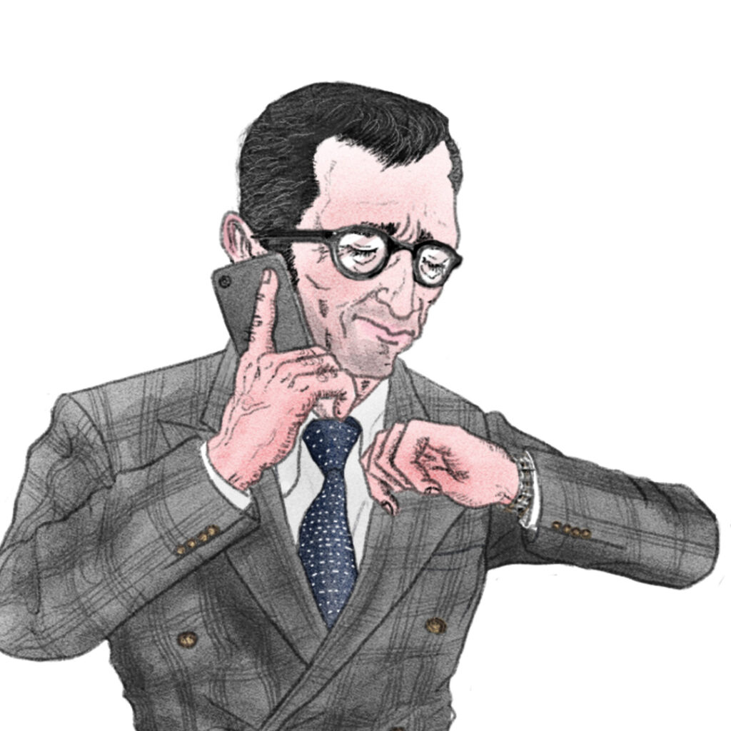 電話しながら時計を見るサラリーマン