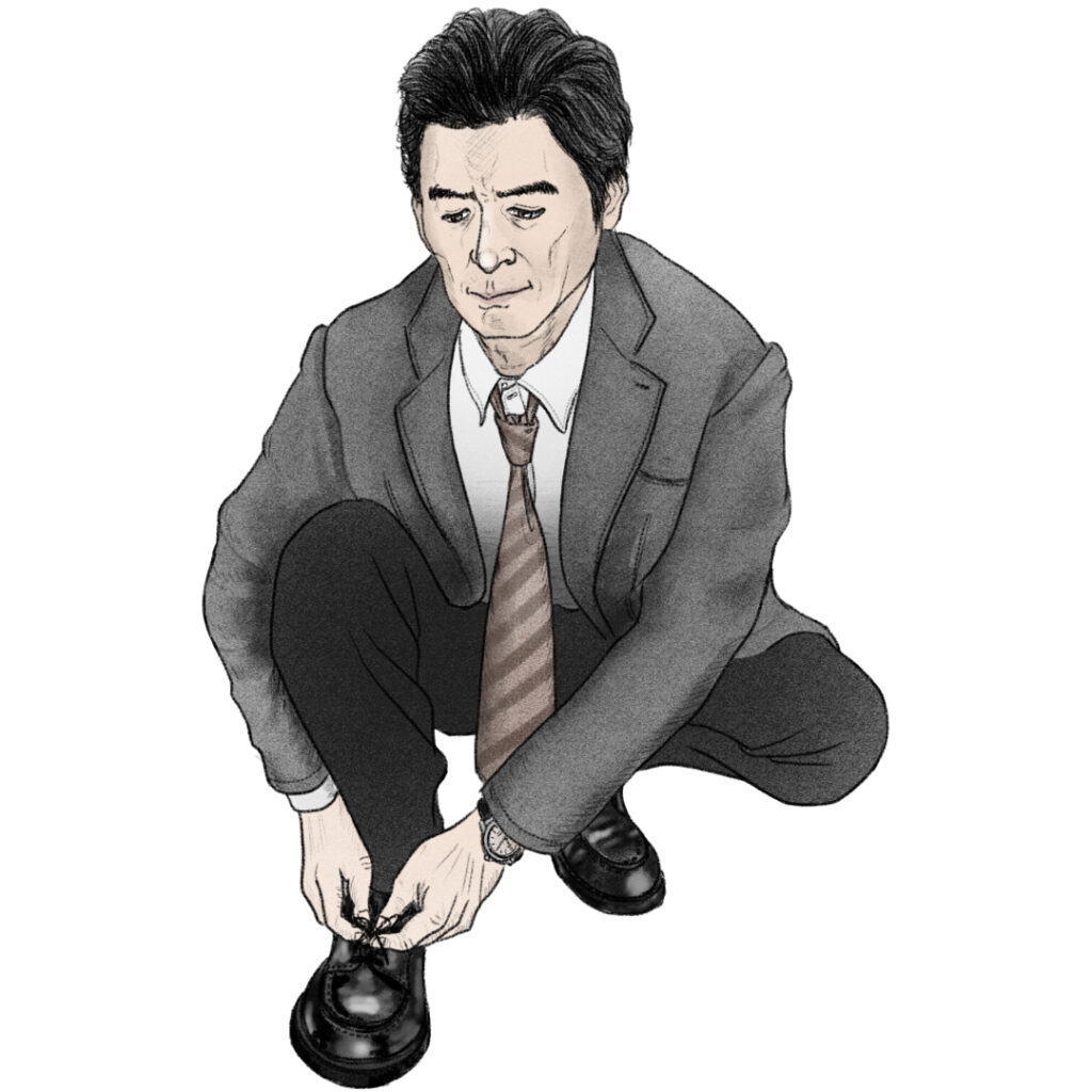 靴ひもを結ぶサラリーマン